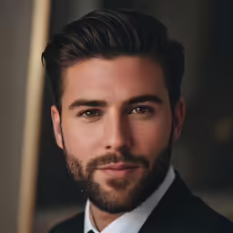 a man with beard and wearing a suit