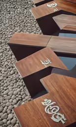 five wood benches side by side in a stone floor