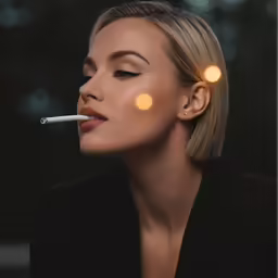 a woman with makeup on her lips smoking