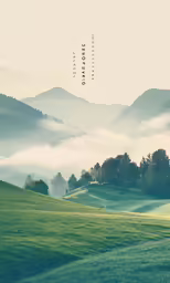 the mountains are covered by clouds, green grass and a sky