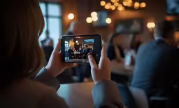 a woman is taking pictures with her phone of a bar