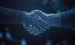 a close up view of two people shaking hands