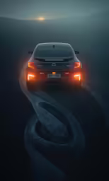 a car on the road in the middle of fog