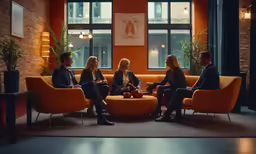 a group of people sitting around in a lobby