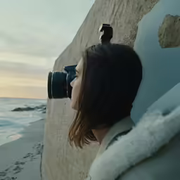 a person standing on a beach next to the ocean