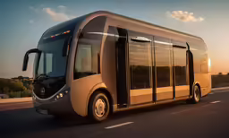 modern bus in motion on road at dusk