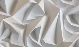 some white sheets of paper that are folded in the same direction
