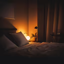 dark room with large bed and large windows