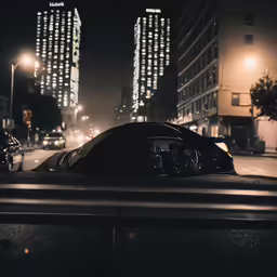 cars at night on the street in front of buildings
