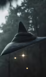 a large black hat is hanging from a wire