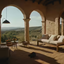 a living area with couch, chairs and open arches