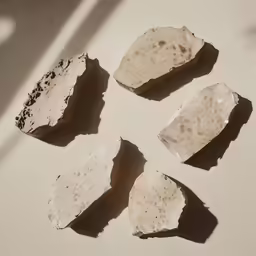 four pieces of stone, one with a cracked surface and the other has rust