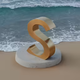 a stone and gold metal number is on the sand near a beach