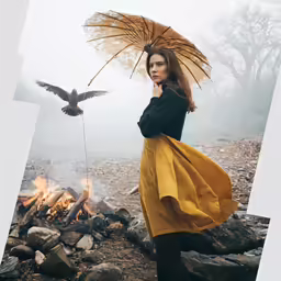 a woman standing in a fire pit with a bird next to her