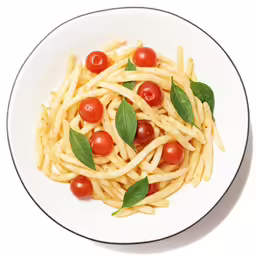 a plate of penna pasta with cherry tomatoes and sage