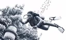 a woman diving out of a pipe while holding her hands in her pants