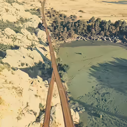 a road stretching into the distance between some hills