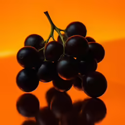 the grapes are on a orange background