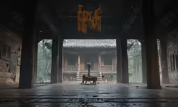two dogs are walking in the dark under a pavilion