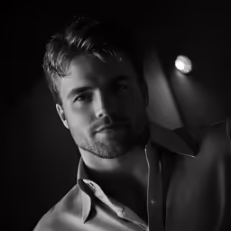 a black and white photo of a man in shirt