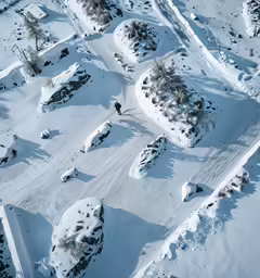 a snowy landscape with snow covered slopes and trees