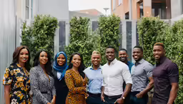 a group of people smile at the camera