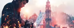 a man taking a picture of some buildings in the snow