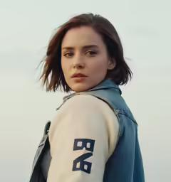 a young woman poses against a white sky