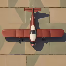 a small, modern airplane on an orange cement pavement
