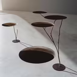 three metal objects sitting in the middle of a room