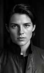 a black and white photo of a person in a leather jacket