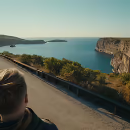 a young boy watches as he stands on a bridge