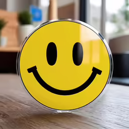 yellow smiley face on table next to window