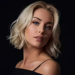 a woman with blonde hair wearing a strapless top