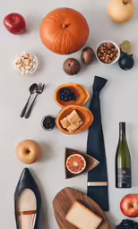a white table has fruit and a variety of food
