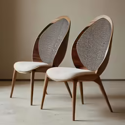 two chairs with white upholstered back cushions