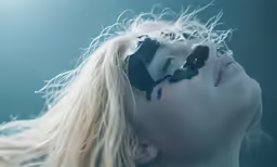 the woman is covered with black makeup and hair