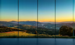 a glass wall with a view of hills in the background