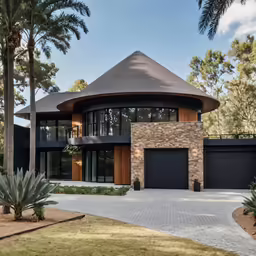 a nice modern house that is built in some sort of landscape