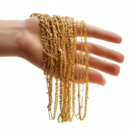 a person holds out their arm covered with gold chains