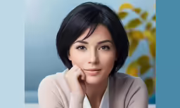 asian woman wearing a cream sweater posing for a portrait
