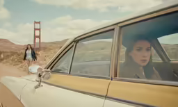 a woman sitting in the passenger seat of a car