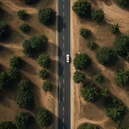 an aerial shot of a road in the desert