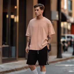 the man is walking down the street with his foot in his pocket
