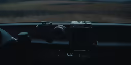 an open car door is showing a camera on the dash