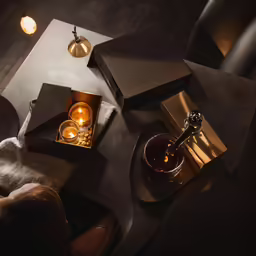 a couple of golden candles sit on a table