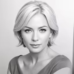 a woman with short blonde hair posing for a picture
