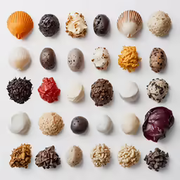 nine chocolates sitting on a white surface and all half eaten