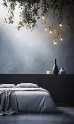 a bed is next to some vases and a tree branch