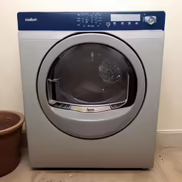 a dryer in a small room with a basket